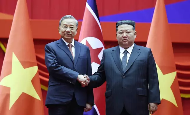 North Korean leader Kim Jong Un, right, and Vietnamese General Secretary of Communist Party To Lam shake hands in Pyongyang, North Korea, Thursday, Oct. 9, 2025. (Hoang Thong Nhat/VNA via AP)