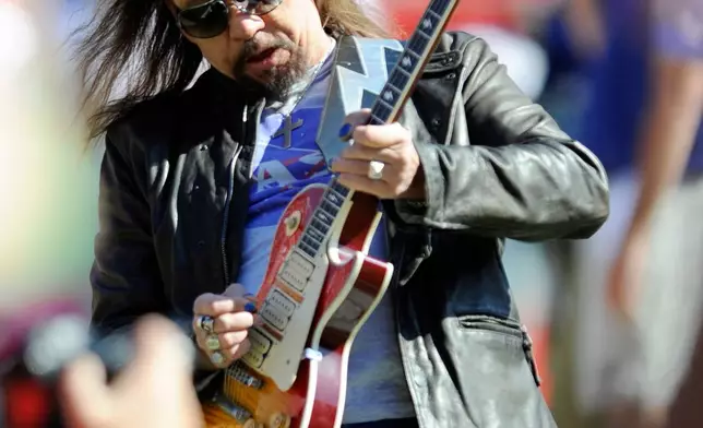 FILE - In this Oct. 4, 2009 file photo, former KISS lead guitarist Ace Frehley plays the national anthem before an NFL football game between the Kansas City Chiefs and the New York Giants in Kansas City, Mo. (AP Photo/L.G. Patterson, File)