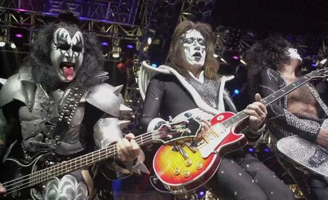 FILE - Kiss guitarist Paul Stanley, right, guitarist Ace Frehley, center, and bassist Gene Simmons play during the band's farewell concert in the Detroit area, Thursday, May 25, 2000, at the Palace of Auburn Hills, Mich.. (AP Photo/Paul Warner, File)