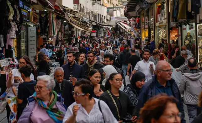 People walk along the popular Mahmutpaşa Street in the Eminonu commercial area of Istanbul, Turkey, Thursday, Oct. 2, 2025. (AP Photo/Emrah Gurel)
