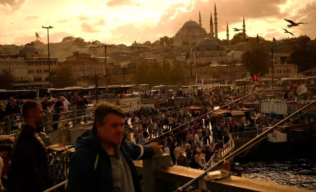 People stroll through Eminonu, a bustling commercial district by the Golden Horn in Istanbul, Turkey, Saturday, Sept. 27, 2025. (AP Photo/Emrah Gurel)