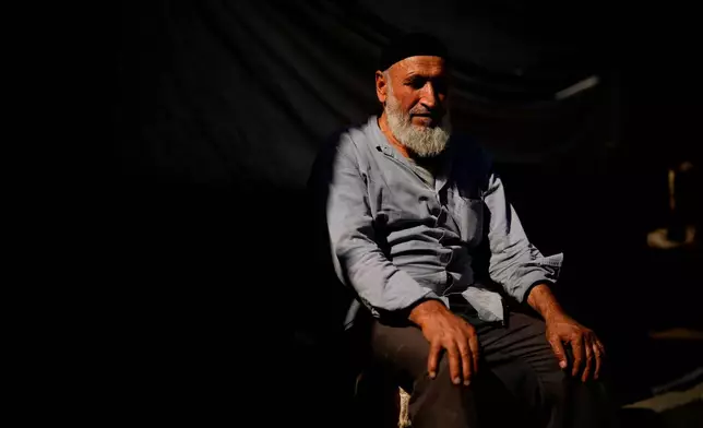 Mevlut, a 75-year-old porter, poses for a portrait while he takes a break in Istanbul, Turkey, Thursday, Sept. 25, 2025. (AP Photo/Emrah Gurel)