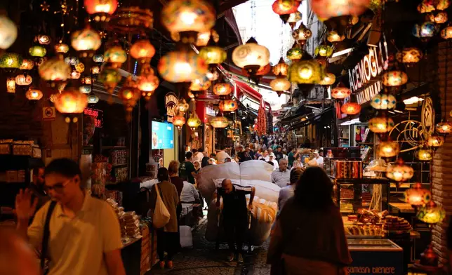 A porter pulls a trolley loaded with goods in the popular Eminonu commercial area of Istanbul, Turkey, Wednesday, Sept. 24, 2025. (AP Photo/Emrah Gurel)