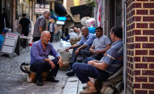 Porters take a break near the Grand Bazaar in Istanbul, Turkey, Thursday, Sept. 25, 2025. (AP Photo/Emrah Gurel)