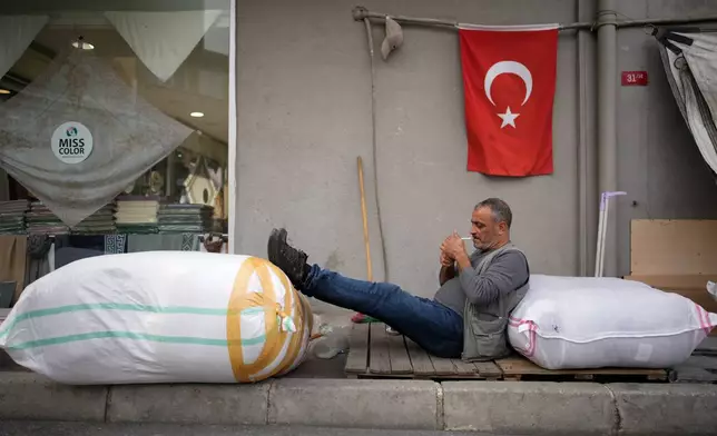 Suat Demir, a 52-year-old parter, smokes a cigarette after finishing his work day in Istanbul, Turkey, Thursday, Oct. 2, 2025. (AP Photo/Emrah Gurel)
