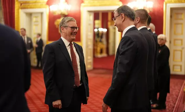 Britain's Prime Minister Sir Keir Starmer, left, speaks with the President of the Government of the Republic of Serbia Duro Macut, during a reception for Western Balkans leaders at St James's Palace, London, Tuesday, Oct. 21, 2025, on the eve of the Western Balkans Leaders' Summit. (Aaron Chown/Pool Photo via AP)