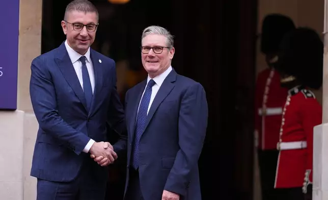 Britain's Prime Minister Keir Starmer welcomes North Macedonia's Prime Minister Hristijan Mickoski to a meeting of leaders of six Western Balkan nations with British and European officials at a Western Balkans Summit in London, Wednesday, Oct. 22, 2025.(AP Photo/Kirsty Wigglesworth, Pool)