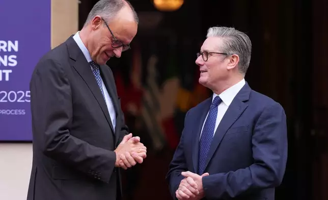 Britain's Prime Minister Keir Starmer welcomes German Chancellor Friedrich Merz to a meeting of leaders of six Western Balkan nations with British and European officials at a Western Balkans Summit in London, Wednesday, Oct. 22, 2025.(AP Photo/Kirsty Wigglesworth, Pool)