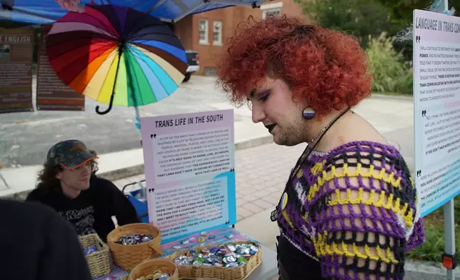 Phoenix Bilodeau stops at a booth during Pride Fest in Wake Forest, N.C., on Saturday, Oct. 11, 2025. Bilodeau, who is trans, said they feel in danger in the current political climate. (AP Photo/Allen G. Breed)