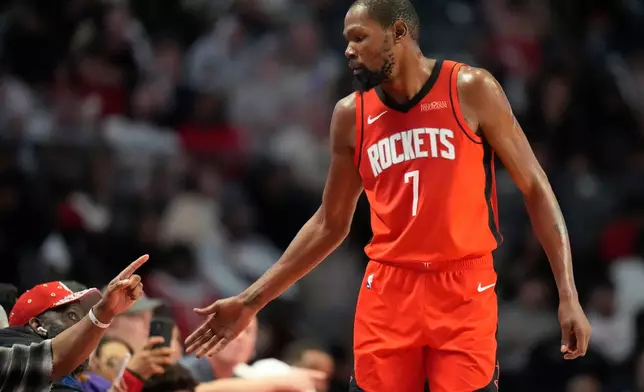 Houston Rockets forward Kevin Durant (7) greets fans during the second half of an NBA preseason basketball game against the New Orleans Pelicans, Tuesday, Oct. 14, 2025, in Birmingham, Ala. (AP Photo/Mike Stewart)