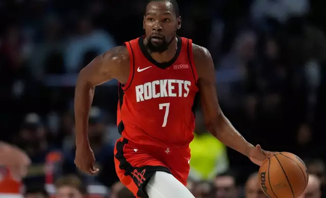 Houston Rockets forward Kevin Durant (7) moves the ball against the New Orleans Pelicans during the first half of an NBA preseason basketball game, Tuesday, Oct. 14, 2025, in Birmingham, Ala. (AP Photo/Mike Stewart)