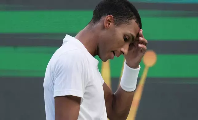 Felix Auger-Aliassime of Canada reacts after losing a point to Arthur Rinderknech of France during their men's singles quarterfinal match of the Shanghai Masters tennis tournament at Qizhong Forest Sports City Tennis Center, in Shanghai, China, Friday, Oct. 10, 2025. (AP Photo/Andy Wong)