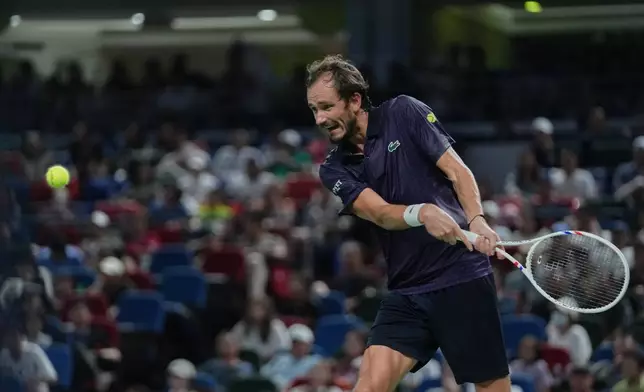 Daniil Medvedev of Russia prepares to return a backhand shot from Alex De Minaur of Australia during their men's singles quarterfinal match of the Shanghai Masters tennis tournament at Qizhong Forest Sports City Tennis Center, in Shanghai, China, Friday, Oct. 10, 2025. (AP Photo/Andy Wong)
