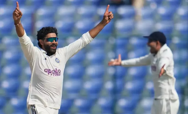 India's Ravindra Jadeja, left, celebrates the dismissal of West Indies' John Campbell with his teammates on the fourth day of the second cricket test match between India and West Indies at the Arun Jaitley Stadium in New Delhi, India, Monday, Oct.13, 2025. (AP Photo/Manish Swarup)