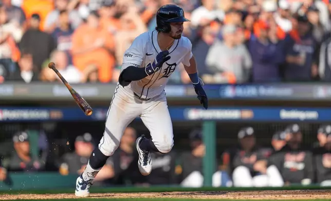 Detroit Tigers' Zach McKinstry follows through on an RBI single during the sixth inning in Game 4 of baseball's American League Division Series against the Seattle Mariners Wednesday, Oct. 8, 2025, in Detroit. (AP Photo/Paul Sancya)