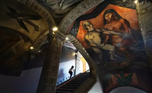 A 1926 fresco of Hernan Cortes and La Malinche by Jose Clemente Orozco decorates the Antiguo Colegio de San Ildefonso in Mexico City, Wednesday, April 26, 2023. (AP Photo/Marco Ugarte)