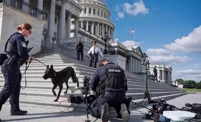 U.S. Capitol Police secure the steps of the House of Representatives before Minority Leader Hakeem Jeffries, D-N.Y., meets with reporters about the government shutdown, at the Capitol in Washington, Thursday, Oct. 2, 2025. (AP Photo/J. Scott Applewhite)