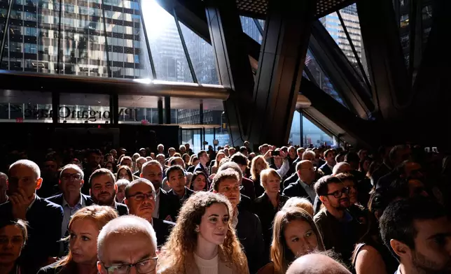 JPMorgan Chase employees and supporters listen to speeches in the lobby of the new building during a ribbon cutting ceremony in New York, Tuesday, Oct. 21, 2025. (AP Photo/Seth Wenig)