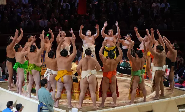 Sumo wrestlers, called rikishi, celebrate the opening on the dohyo, the sacred sumo wrestling ring, during The Grand Sumo Tournament at the Royal Albert Hall in London, Wednesday, Oct. 15, 2025.(AP Photo/Frank Augstein)