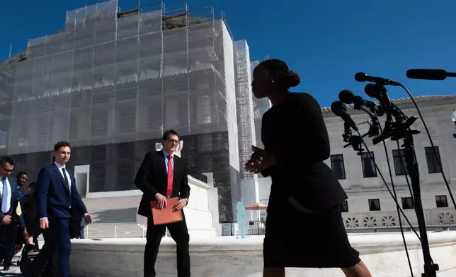 Janai Nelson, right, president of the NAACP Legal Defense Fund, who was arguing on behalf of a group of Black voters, leaves the court after speaking with the news media, Wednesday, Oct. 15, 2025, in Washington. (AP Photo/Cliff Owen)