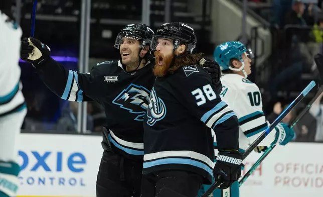 Utah Mammoth center Liam O'Brien (38) celebrates the goal with left wing Brandon Tanev (13) against San Jose Sharks during the second period of an NHL hockey game Friday, Oct. 17, 2025, in Salt Lake City. (AP Photo/Melissa Majchrzak)