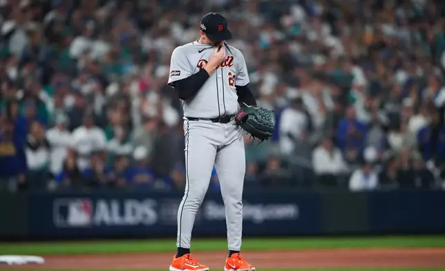 Detroit Tigers pitcher Tarik Skubal wipes his face during the third inning in Game 5 of baseball's American League Division Series against the Seattle Mariners, Friday, Oct. 10, 2025, in Seattle. (AP Photo/Lindsey Wasson)