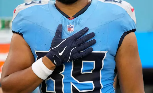 FILE - Tennessee Titans tight end Thomas Odukoya (89) holds his hand on his heart during the national anthem before a preseason NFL football game against the Minnesota Vikings, Friday, Aug. 22, 2025, in Nashville, Tenn. (AP Photo/George Walker IV, File)