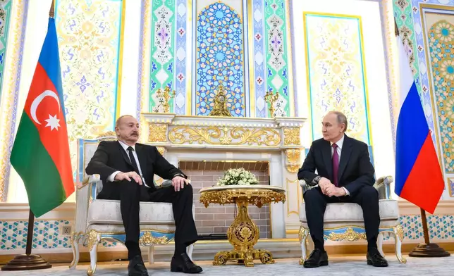 Russian President Vladimir Putin, right, and Azerbaijan's President Ilham Aliyev talk during their meeting on the sidelines of the Russia-Central Asia summit in Dushanbe, Tajikistan, on Thursday, Oct. 9, 2025. (Grigory Sysoyev, Sputnik, Kremlin Pool Photo via AP)