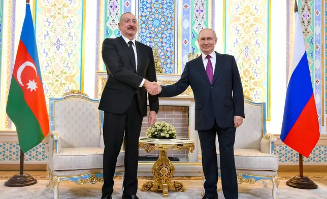 Russian President Vladimir Putin, right, and Azerbaijan's President Ilham Aliyev shake hands prior to their talks on the sidelines of the Russia-Central Asia summit in Dushanbe, Tajikistan, on Thursday, Oct. 9, 2025. (Grigory Sysoyev, Sputnik, Kremlin Pool Photo via AP)