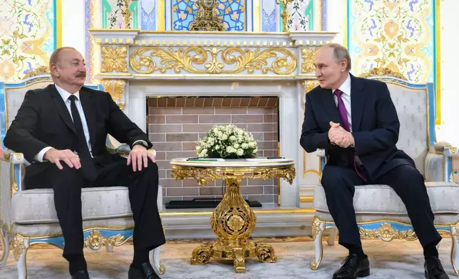Russian President Vladimir Putin, right, and Azerbaijan's President Ilham Aliyev talk during their meeting on the sidelines of the Russia-Central Asia summit in Dushanbe, Tajikistan, on Thursday, Oct. 9, 2025. (Grigory Sysoyev, Sputnik, Kremlin Pool Photo via AP)