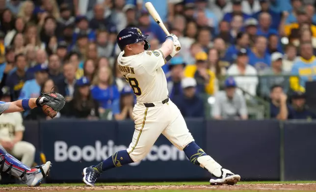 Milwaukee Brewers first baseman Andrew Vaughn (28) hits a solo home run against the Chicago Cubs during the fourth inning of Game 5 of baseball's National League Division Series, Saturday, Oct. 11, 2025, in Milwaukee. (AP Photo/Kayla Wolf)