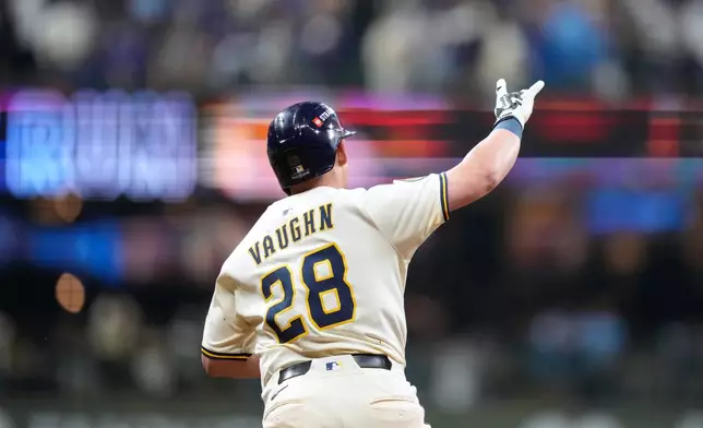 Milwaukee Brewers first baseman Andrew Vaughn (28) reacts after hitting a solo home run against the Chicago Cubs during the fourth inning of Game 5 of baseball's National League Division Series, Saturday, Oct. 11, 2025, in Milwaukee. (AP Photo/Kayla Wolf)