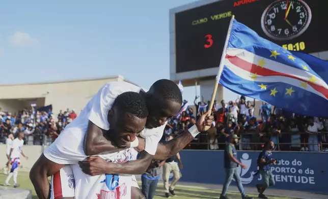 Cape Verde's Stopira, bottom, celebrates with his teammate after defeating Eswatini in a World Cup qualifying soccer match at Estádio Nacional in Praia, Cape Verde, Monday, Oct. 13, 2025, to clinch their qualification for the 2026 World Cup. (AP Photo/Cristiano Barbosa)