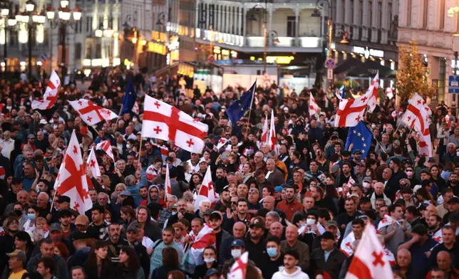 Opposition supporters with Georgian national and EU flags gather in the city center of Tbilisi, Georgia, on Saturday, Oct. 4, 2025, boycotting the municipal elections and call for the release of political opponents. (AP Photo/Zurab Tsertsvadze)