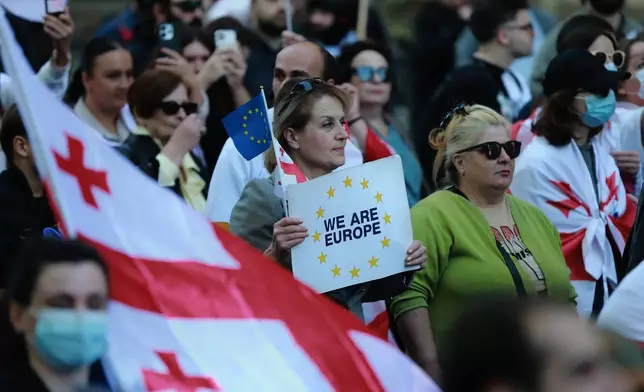Opposition supporters with Georgian national flags gather in the city center of Tbilisi, Georgia, on Saturday, Oct. 4, 2025, boycotting the municipal elections and call for the release of political opponents. (AP Photo/Zurab Tsertsvadze)