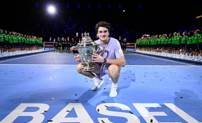 Brazil's Joao Fonseca poses with the trophy after winning the final match against Spain's Alejandro Davidovich Fokina at the Swiss Indoors tennis tournament in Basel, Switzerland, Sunday, Oct. 26, 2025. (Georgios Kefalas/Keystone via AP)