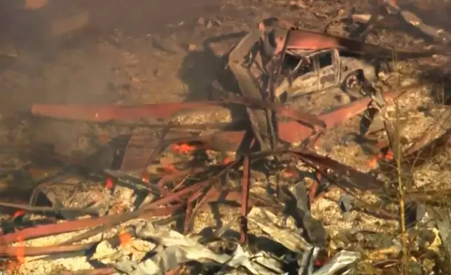 Debris covers the ground and vehicles after a powerful blast ripped through a military explosives manufacturing plant in Hickman County, Tenn., on Friday, Oct. 10, 2025. (WTVF-TV via AP)
