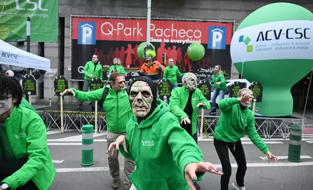 People dressed as zombies march during a demonstration and general strike in Brussels, Tuesday, Oct. 14, 2025. (AP Photo/Harry Nakos)