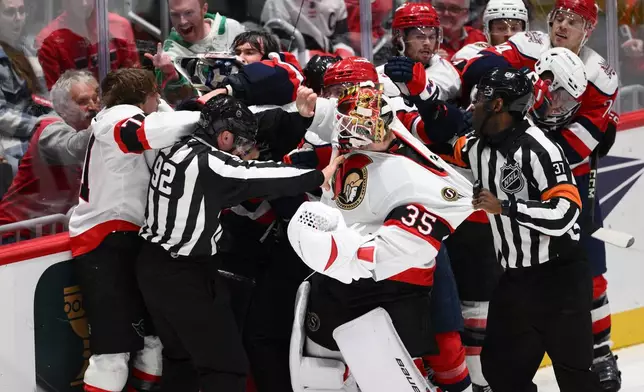 The Washington Capitals and Ottawa Senators brawl during the second period of an NHL hockey game, Saturday, Oct. 25, 2025, in Washington. (AP Photo/Nick Wass)
