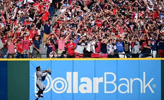 Detroit Tigers right fielder Wenceel Pérez watches as a three-run homer hit by Cleveland Guardians' Bo Naylor flies over the wall in the eighth inning of Game 2 of the American League Wild Card baseball playoff series in Cleveland, Wednesday, Oct. 1, 2025. (AP Photo/David Dermer)