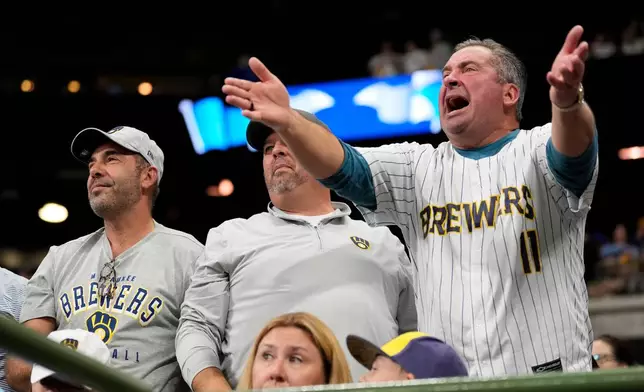 Milwaukee Brewers fans react during the sixth inning in Game 2 of baseball's National League Championship Series against the Los Angeles Dodgers, Tuesday, Oct. 14, 2025, in Milwaukee. (AP Photo/Brynn Anderson)