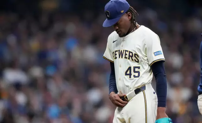 Milwaukee Brewers pitcher Abner Uribe leaves the game against the Los Angeles Dodgers during the seventh inning in Game 2 of baseball's National League Championship Series, Tuesday, Oct. 14, 2025, in Milwaukee. (AP Photo/Brynn Anderson)