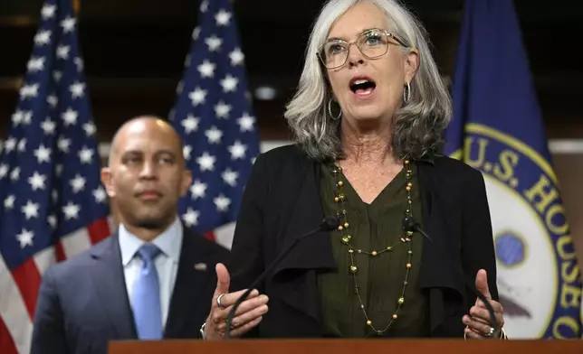 House Minority Leader Hakeem Jeffries, D-N.Y., left, listens to House Minority Whip Katherine Clark, D-Mass., speaks at a news conference on the 8th day of a government shutdown at the U.S. Capitol on Wednesday, Oct. 8, 2025, in Washington. (AP Photo/John McDonnell)