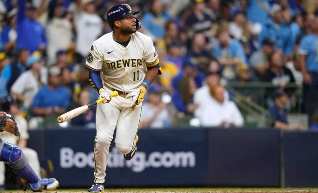 Milwaukee Brewers' Jackson Chourio (11) watches his 3-run home run during the fourth inning of Game 2 of baseball's National League Division Series against the Chicago Cubs Monday, Oct. 6, 2025, in Milwaukee. (AP Photo/Kayla Wolf)