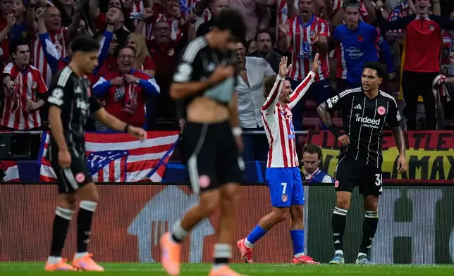 Atletico Madrid's Antoine Griezmann celebrates after scoring his side's third goal during the Champions League opening phase soccer match between Atletico Madrid and Eintracht Frankfurt at the Metropolitano stadium in Madrid, Spain, Tuesday, Sept. 30, 2025. (AP Photo/Manu Fernandez)