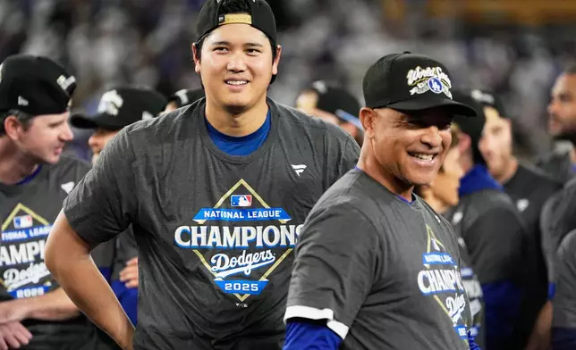 Los Angeles Dodgers pitcher Shohei Ohtani and manager Dave Roberts celebrate their win against the Milwaukee Brewers in baseball's National League Championship Series, Friday, Oct. 17, 2025, in Los Angeles. (AP Photo/Brynn Anderson)