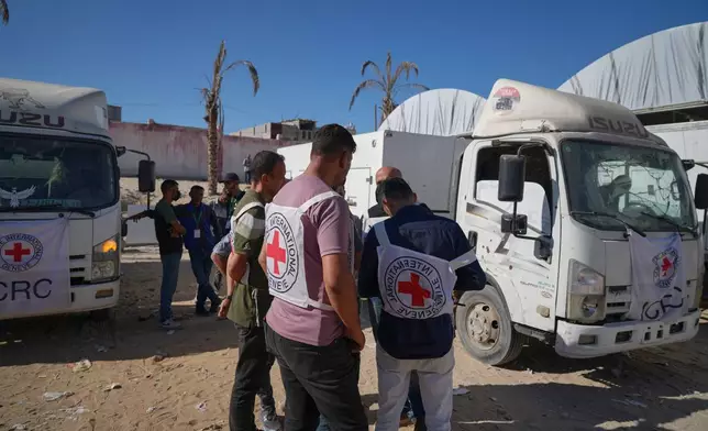 Red Cross vehicles carrying the bodies of deceased Palestinians held by Israel during the war arrive after their release, at the Nasser Hospital in Khan Younis, southern Gaza Strip, Wednesday, Oct. 15, 2025. (AP Photo/Jehad Alshrafi)