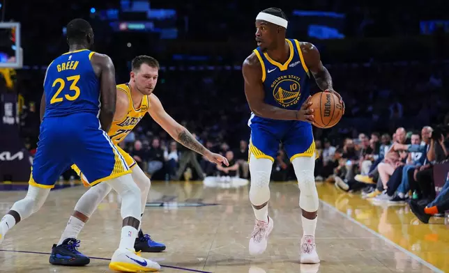 Golden State Warriors forward Jimmy Butler III (10) looks for a passing lane during the first half of an NBA basketball game against the Los Angeles Lakers, Tuesday, Oct. 21, 2025, in Los Angeles. (AP Photo/Ethan Swope)