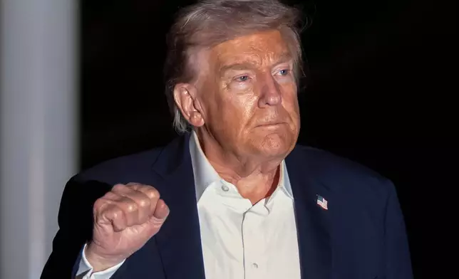 President Donald Trump walks across the South Lawn of the White House, early Tuesday, Oct. 14, 2025, in Washington, after returning from a trip to Israel and Egypt. (AP Photo/Mark Schiefelbein)