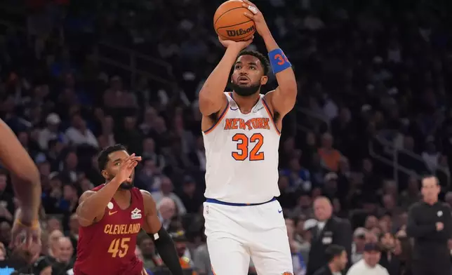 New York Knicks' Karl-Anthony Towns (32) shoots over Cleveland Cavaliers' Donovan Mitchell (45) during the second half of an NBA basketball game Wednesday, Oct. 22, 2025, at Madison Square Garden in New York. (AP Photo/Frank Franklin II)